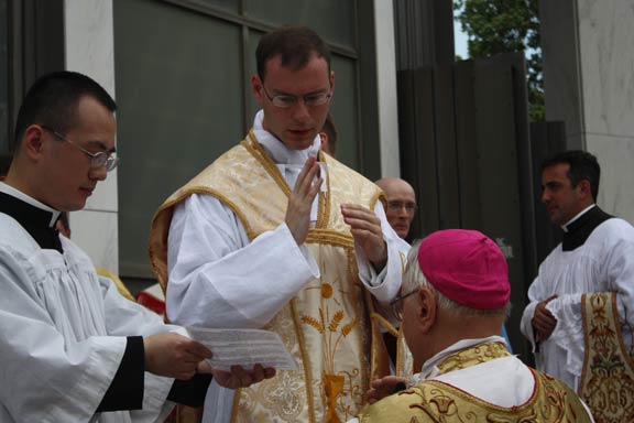 Bishop Bruskewitz Receives a Blessing from Father Kenneth Walker FSSP