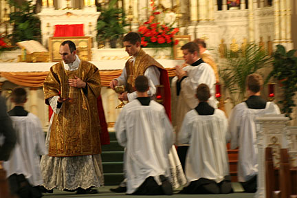 Father Eichman Administering Communion to the Laity