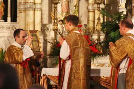 Father Eichman offering the Last Gospel