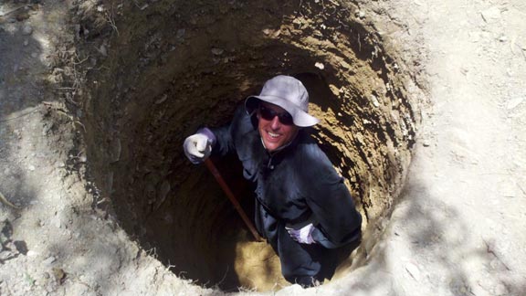 Fr. Lillard down in a hole, performing needed latrine work in Banica.