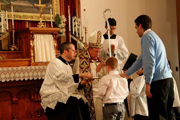 Archbishop administers the Oil of Confirmation