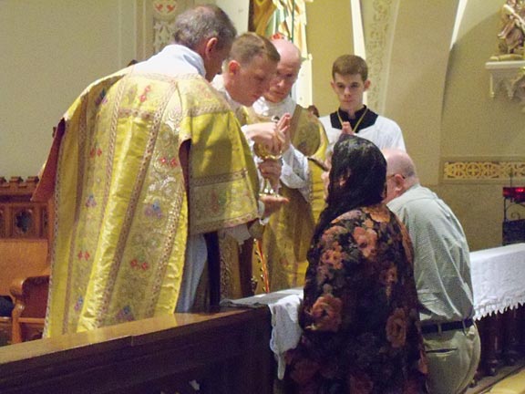 In a Beautiful Moment, Fr. Bartholomew Administers Communion First to His Mother and Father