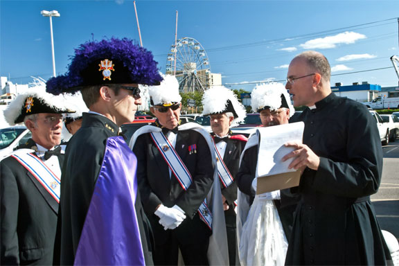 Fr. Neil Nichols, FSSP, coordinates the Knights of Columbus ahead of the procession.