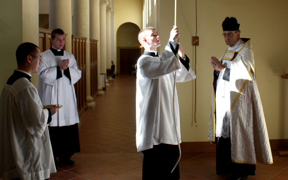 Seminarian Rings the Bell as a Sign of the Order of Acolyte