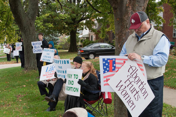 Parishioners of Holy Family display signs and pray for an end to abortion.