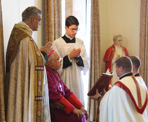 Bishop Bruskewitz offers his preparatory vesting prayers.
