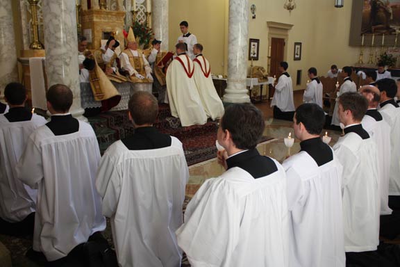 Bishop Bruskewitz concludes his prayers, having invested each man with his cassock and surplice.