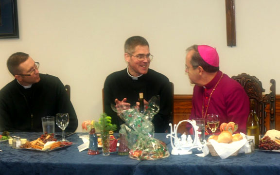 Bishop Bambera Enjoys the Christmas Dinner with Father Flood