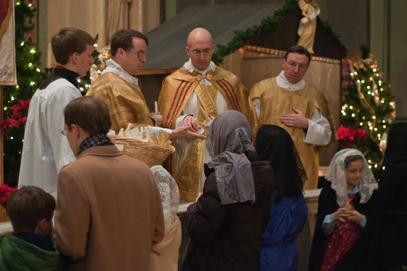 Father Mark Wojdelski, FSSP, Distributes Candles at Holy Family in Dayton